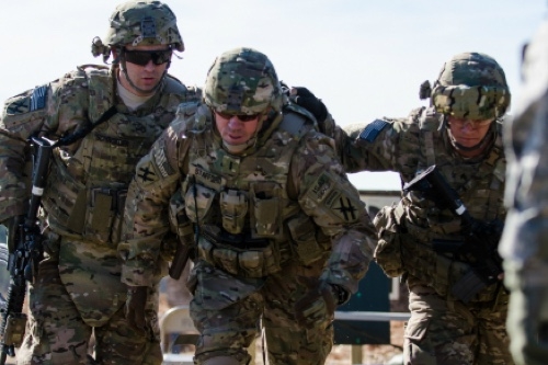 Three military servicemembers walking together