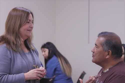 A faculty member talking with a community member