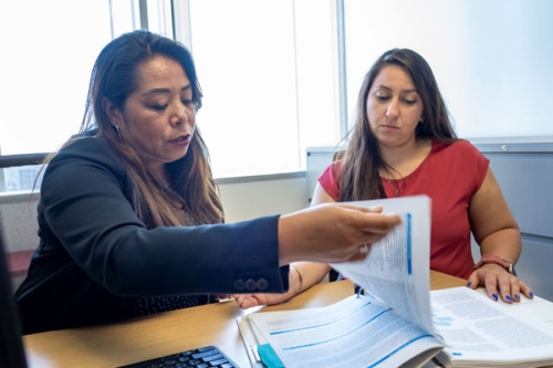 People looking at paperwork together. 